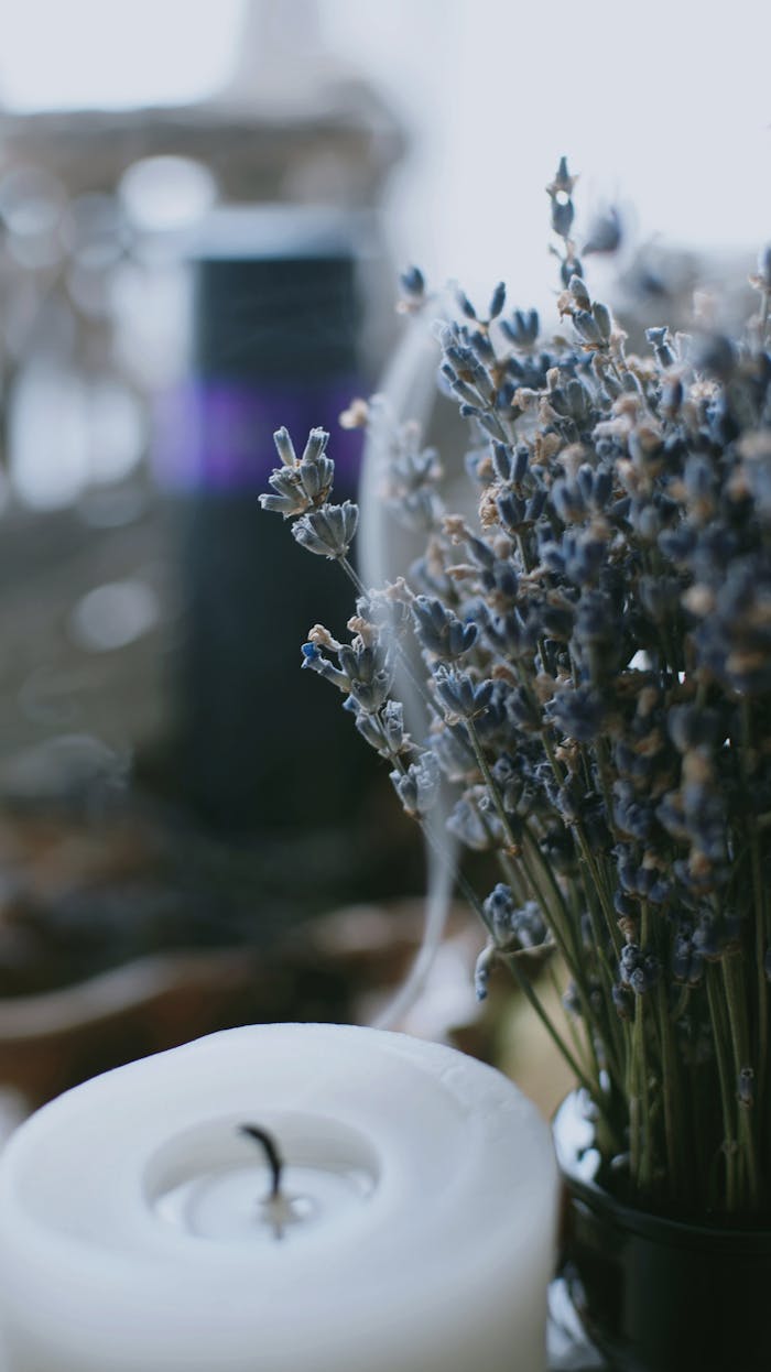 Close-up of lavender flowers with a candle, creating a serene and calming atmosphere.